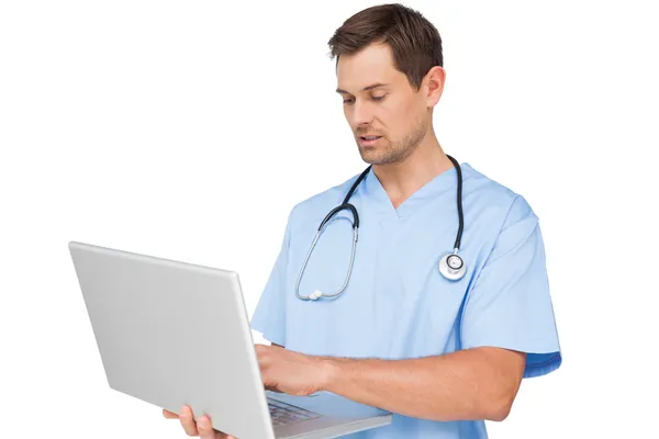 Koncentrerad manliga kirurg med laptop — Stockfoto