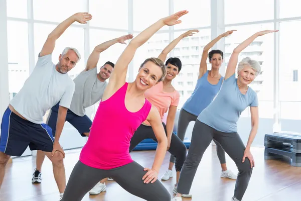Class stretching hands at yoga class — Stock Photo, Image