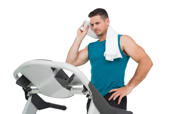 Young man running on a treadmill — Stock Photo, Image