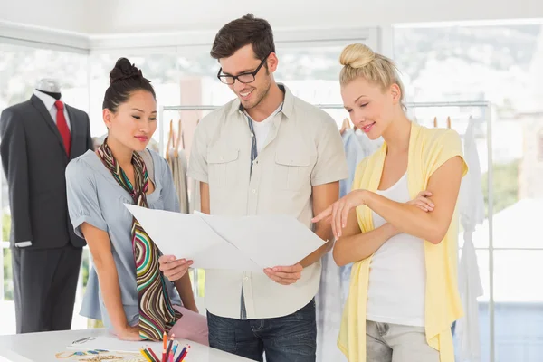 Fashion designers discussing designs — Stock Photo, Image