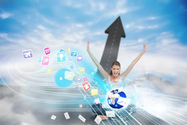 Cheering blonde using laptop with app icons — Stock Photo, Image
