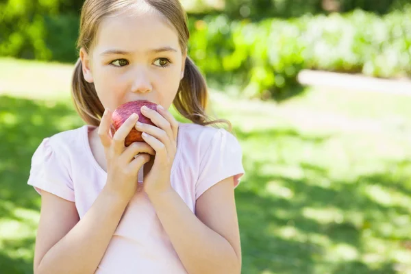 在公园里的女孩吃苹果 — 图库照片