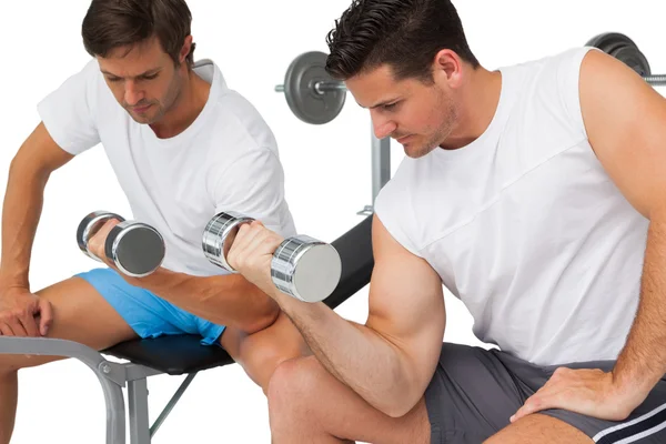 Two fit young men exercising with dumbbells — Stock Photo, Image