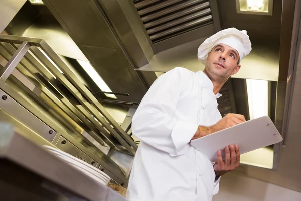 Cook with clipboard in kitchen — Stock Photo, Image