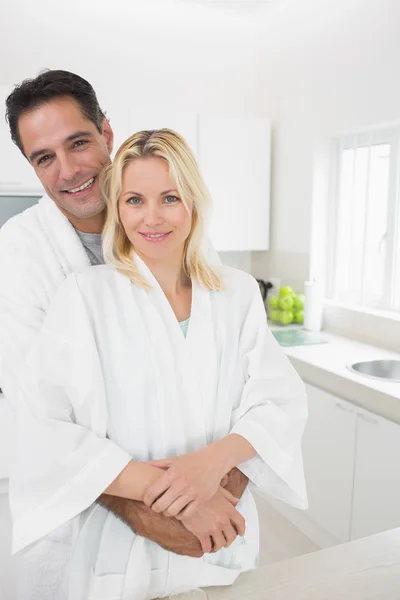 Man embracing woman in kitchen — Stock Photo, Image