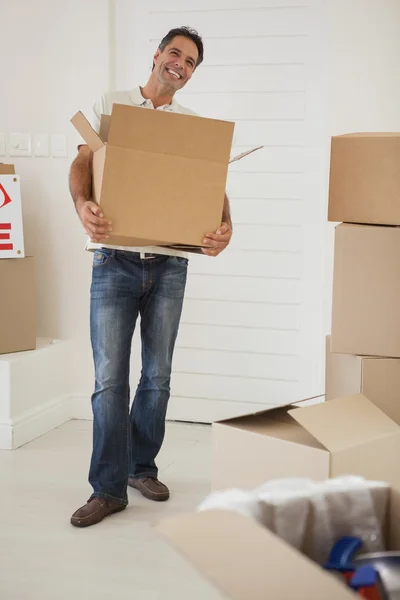 Hombre llevando cajas en casa nueva — Foto de Stock