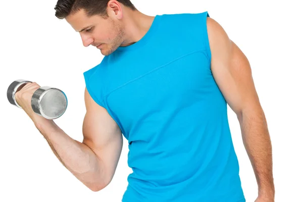 Fit young man exercising with dumbbell — Stock Photo, Image