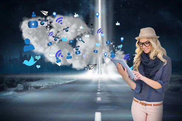 Stylish blonde using tablet pc with app icons and cloud — Stock Photo, Image