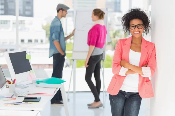 Casual female artist with colleagues in at office — Stock Photo, Image