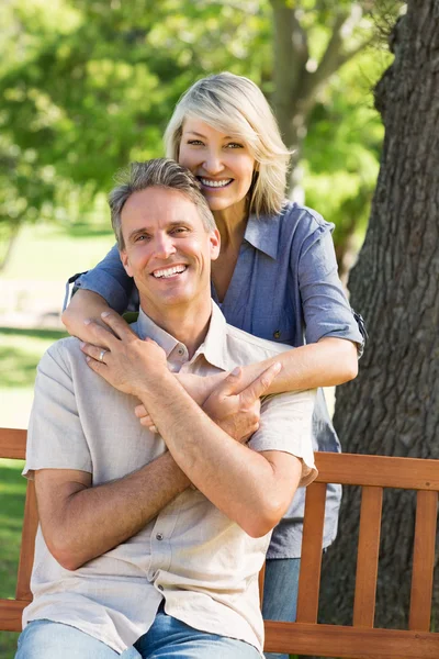 Woman embracing man from behind in park — Stock Photo, Image