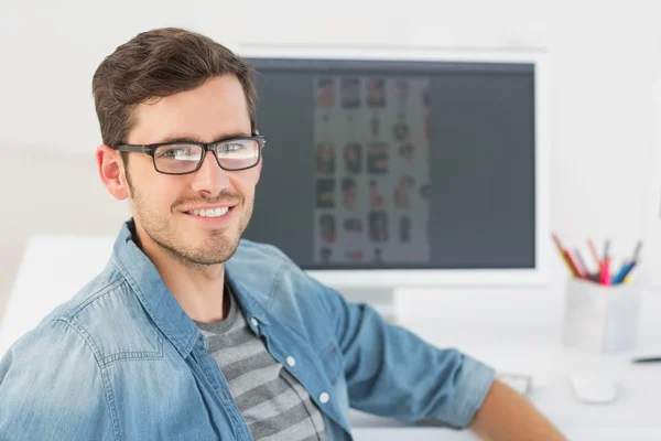 Casual male photo editor in front of computer — Stock Photo, Image