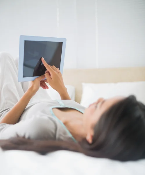 Girl looking up at her tablet pc — Stock Photo, Image