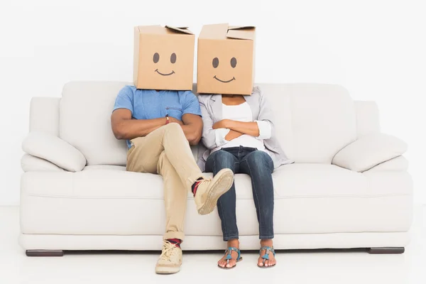 Young couple with happy smiley boxes over faces — Stock Photo, Image