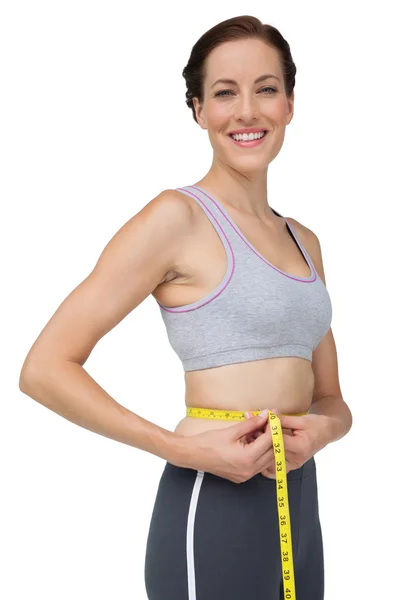 Fit woman measuring waist — Stock Photo, Image