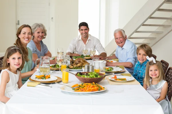 Family having meal together at dining table — Stock Photo, Image