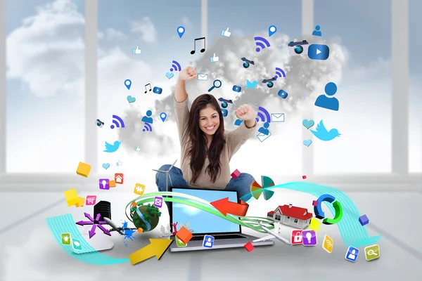 Cheering girl using laptop with app icons — Stock Photo, Image