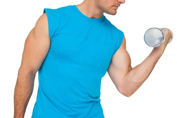 Close-up mid section of fit man exercising with dumbbell — Stock Photo, Image