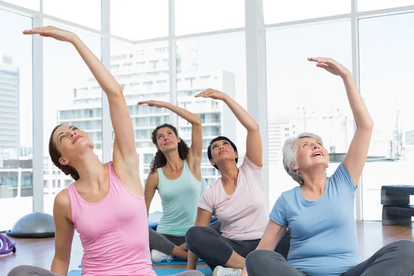 Class stretching hands at yoga class — Stock Photo, Image