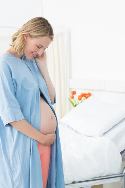 Pregnant woman looking at belly — Stock Photo, Image