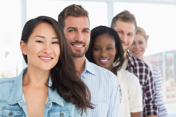 Ontwerp team staan in een rij glimlachen op camera — Stockfoto