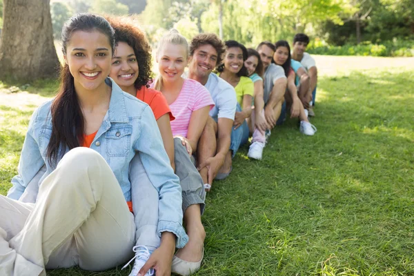 Friends sitting in line on campus — Stock Photo, Image