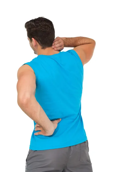 Rear view of man in sportswear suffering from neck ache — Stock Photo, Image