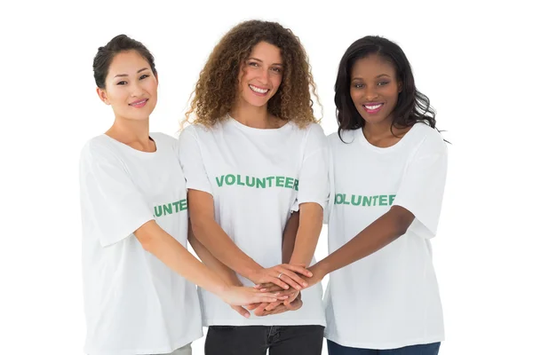 Team of happy volunteers putting hands together — Stock Photo, Image