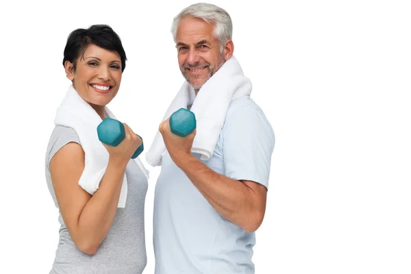 Fit mature couple exercising with dumbbells — Stock Photo, Image