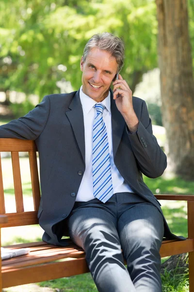 Businessman answering phone — Stock Photo, Image