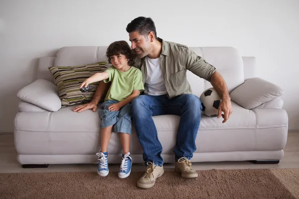 Father and son with football watching tv — Stock Photo, Image
