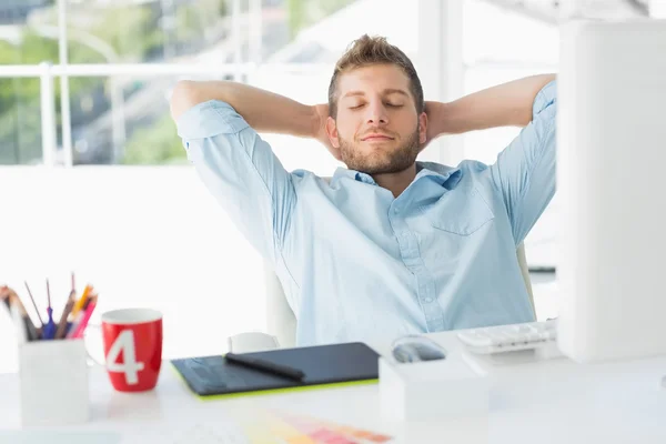 Designer relaxing at his desk — Stock Photo, Image