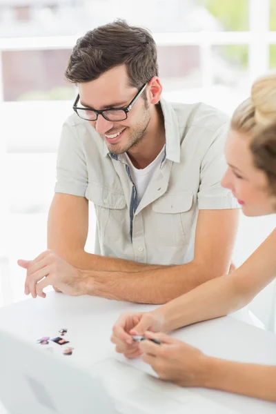 Sorridente giovane uomo e donna che lavorano alla scrivania — Foto Stock