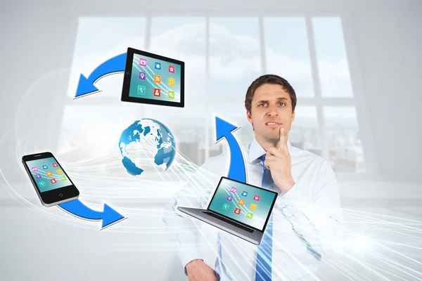Confused businessman with computer connection graphic — Stock Photo, Image