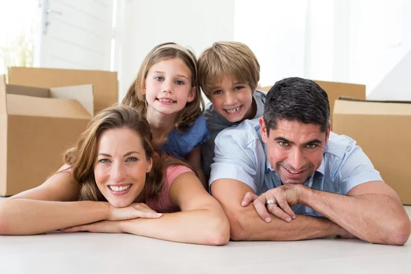 Familie liggend op de vloer in nieuwe huis — Stockfoto