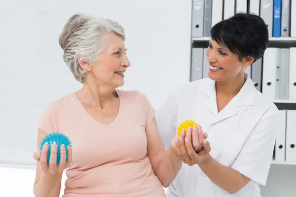 Doctor with senior patient using stress buster balls — Stock Photo, Image