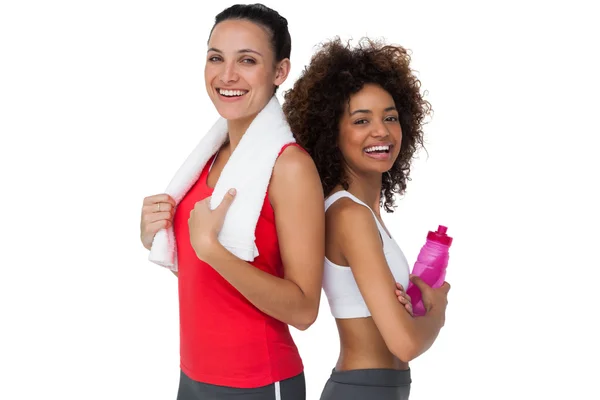 Fit young women standing with waterbottle and towel — Stock Photo, Image