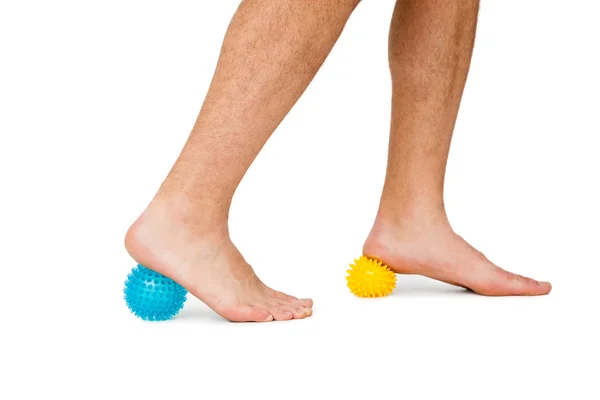 Close-up low section of man standing over stress balls — Stock Photo, Image