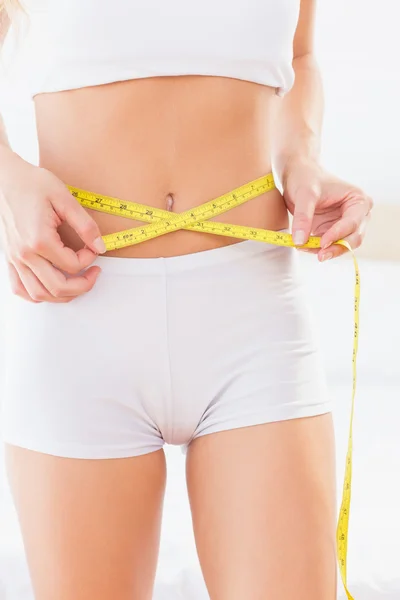 Thin woman measuring her waist — Stock Photo, Image