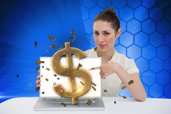 Businesswoman pointing to her laptop showing dollar sign — Stock Photo, Image