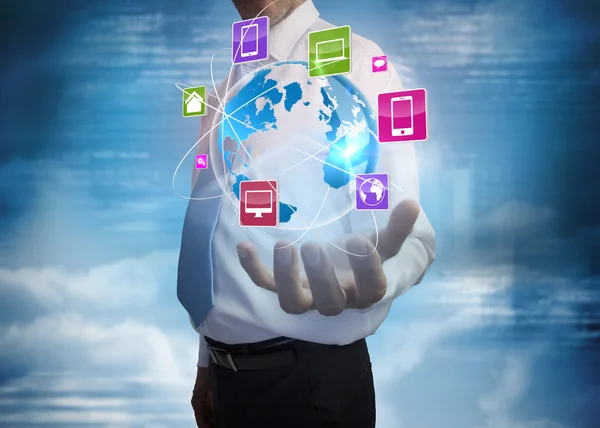 Businessman presenting app icons with earth — Stock Photo, Image