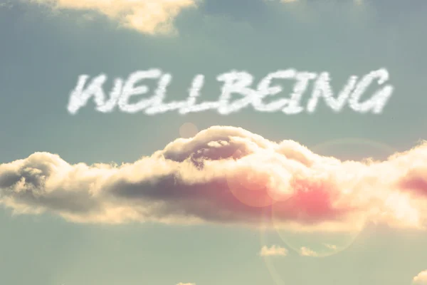Wellbeing - against bright blue sky with cloud — Stock Photo, Image