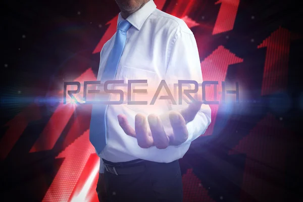 Businessman presenting the word - research — Stock Photo, Image