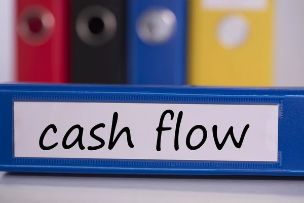 Cash flow on blue business binder — Stock Photo, Image