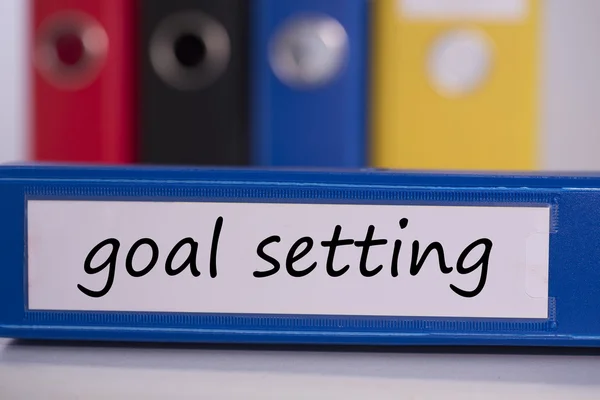 Goal setting on blue business binder — Stock Photo, Image