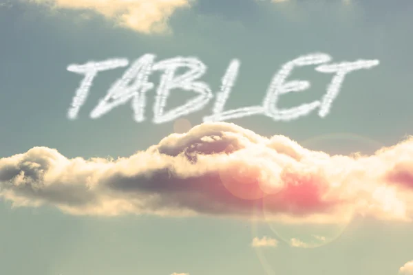 Tablet - against bright blue sky with cloud — Stock Photo, Image