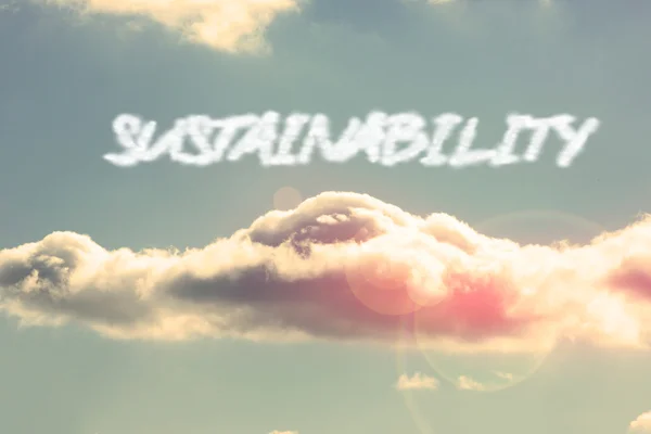 Sustainability - against bright blue sky with cloud — Stock Photo, Image