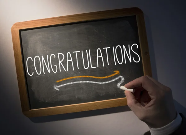 Hand writing Congratulations on chalkboard — Stock Photo, Image