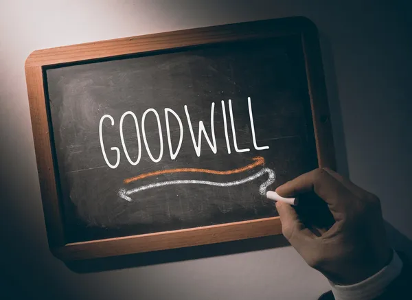 Hand writing Goodwill on chalkboard — Stock Photo, Image