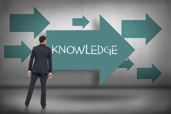 Knowledge - against blue arrows pointing — Stock Photo, Image