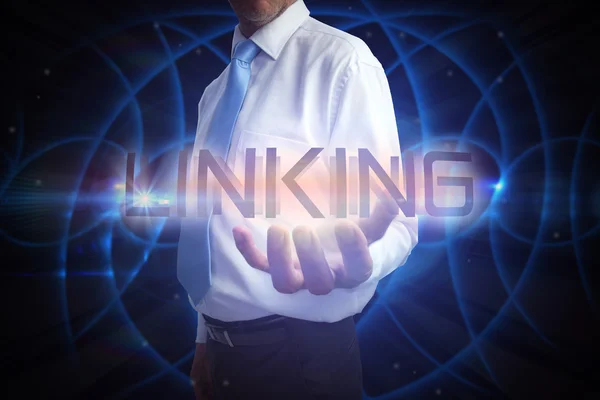 Businessman presenting the word linking — Stock Photo, Image